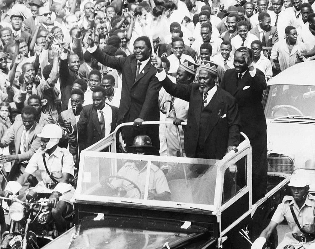 (Original Caption) 6/1/1963-Nairobi, Kenya- Waving his wisk the newly-elected Premier of Kenya, Jomo Kenyatta, (R, foreground), greeted throngs of cheering citizens as he rode through the streets of Nairobi.